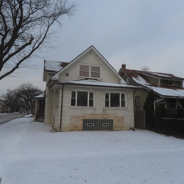 view of snow covered back of property