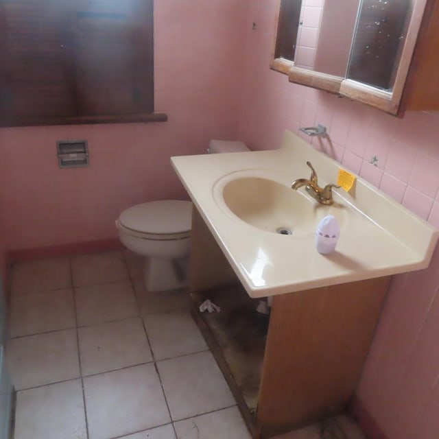 bathroom featuring tile walls, vanity, tile patterned flooring, toilet, and decorative backsplash