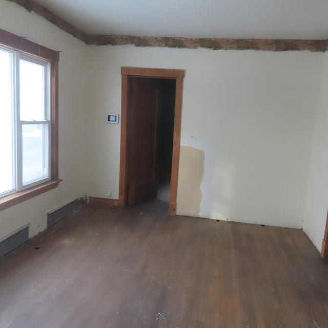 spare room with dark hardwood / wood-style flooring