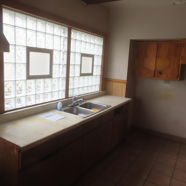 kitchen with sink and dark tile patterned flooring