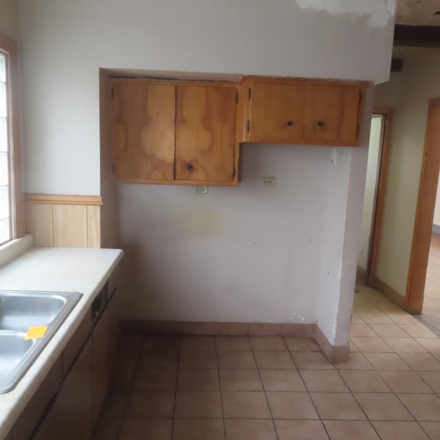 kitchen with sink and light tile patterned flooring