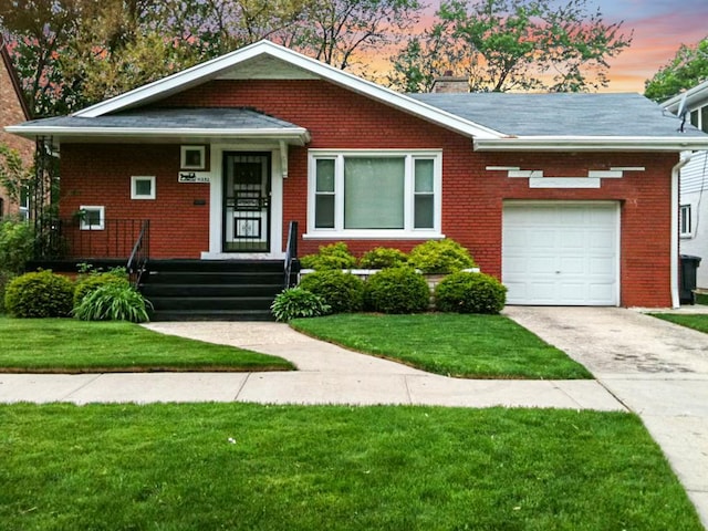 view of front facade with a garage and a lawn