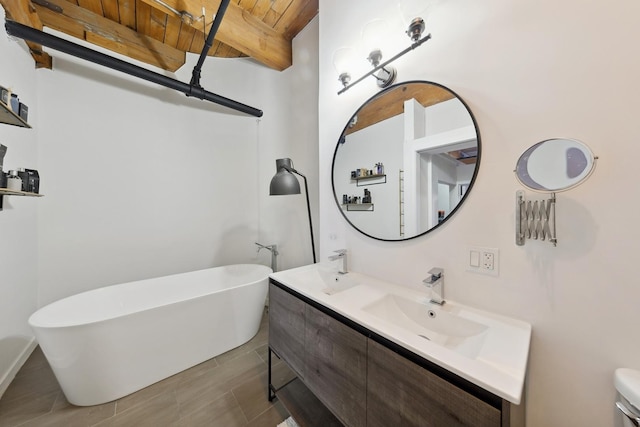 full bathroom with double vanity, wood ceiling, beamed ceiling, a freestanding bath, and a sink