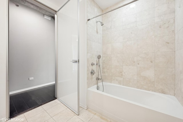 bathroom with shower / washtub combination, baseboards, and tile patterned floors