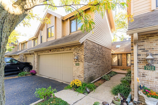 7914 S Garfield Ave, Burr Ridge, IL 60527 - view of front of property featuring a garage, brick siding, driveway, and roof with shingles