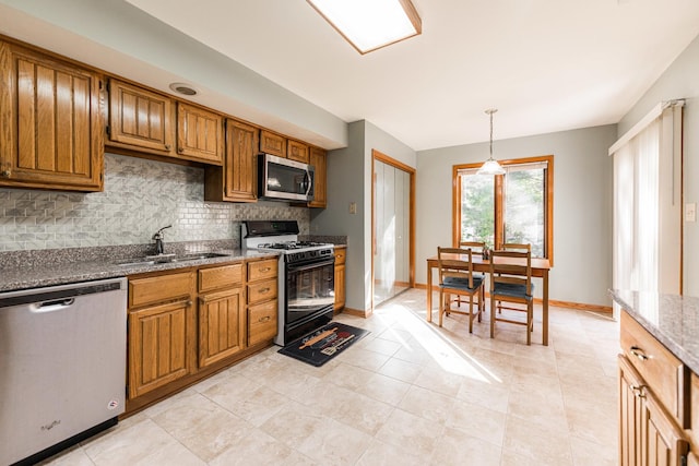 7914 S Garfield Ave, Burr Ridge, IL 60527 - kitchen featuring stainless steel appliances, decorative backsplash, brown cabinetry, light stone countertops, and decorative light fixtures