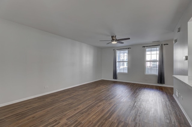 spare room featuring ceiling fan and dark hardwood / wood-style floors