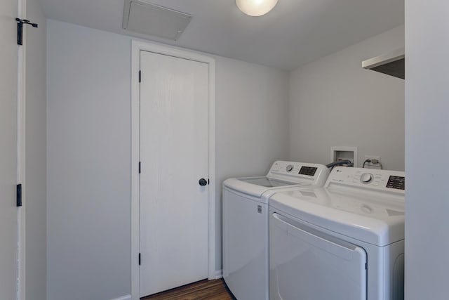 washroom with dark wood-type flooring and separate washer and dryer