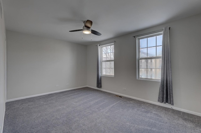 unfurnished room featuring ceiling fan and carpet flooring