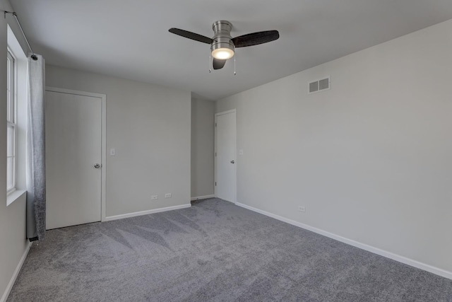 spare room with ceiling fan and carpet flooring