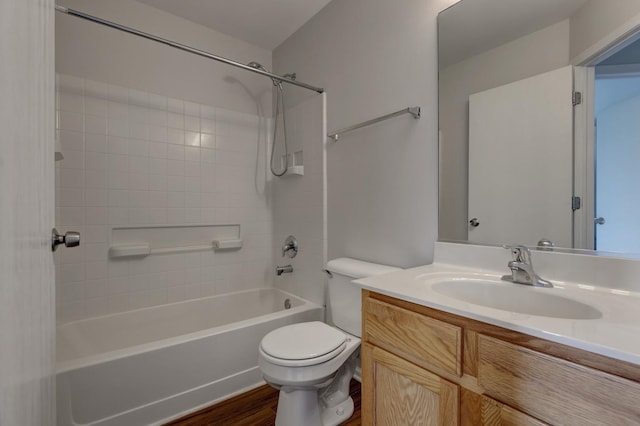 full bathroom with hardwood / wood-style flooring, toilet, vanity, and shower / bathing tub combination