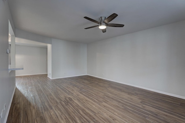 unfurnished room with dark hardwood / wood-style floors and ceiling fan