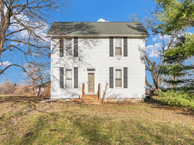 colonial house with entry steps and a front lawn