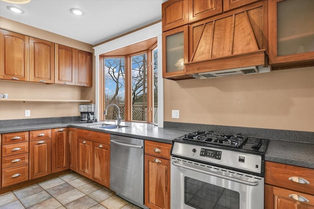 kitchen featuring a sink, brown cabinets, dark countertops, and appliances with stainless steel finishes