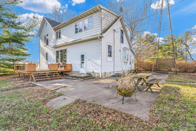 back of house featuring a patio area and a deck