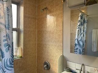 bathroom with shower / bath combo and a sink