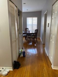 hall with wood finished floors and baseboards