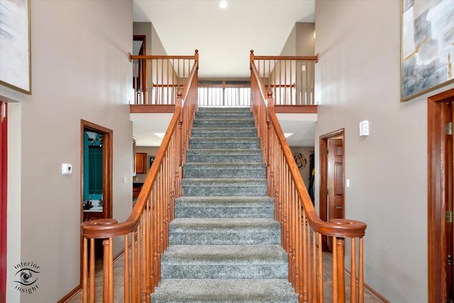 stairway featuring a high ceiling