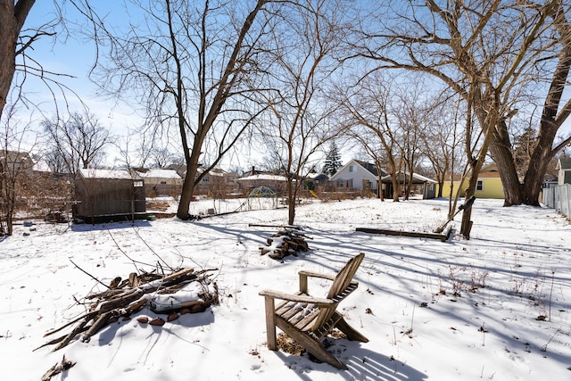 yard layered in snow with a residential view