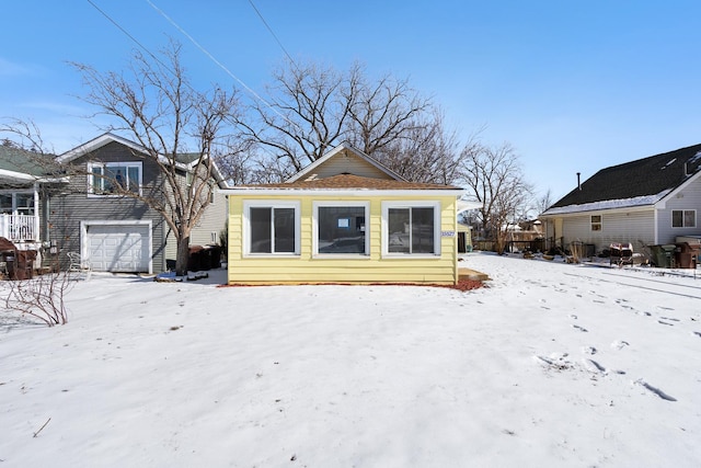 view of snow covered rear of property