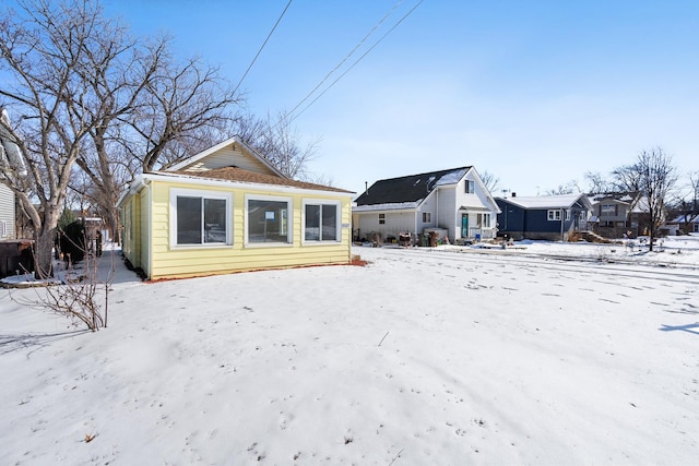 view of snow covered back of property