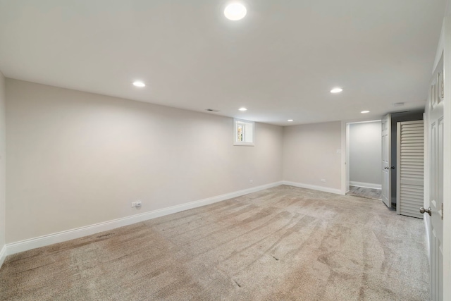 basement featuring light carpet