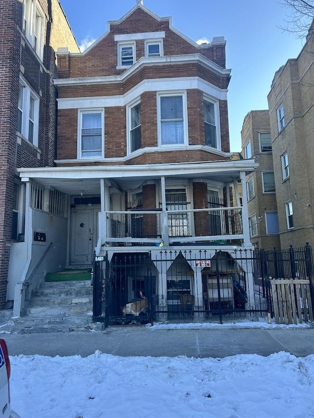 multi unit property featuring fence and brick siding