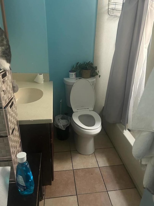 full bathroom featuring shower / tub combo with curtain, vanity, toilet, and tile patterned floors