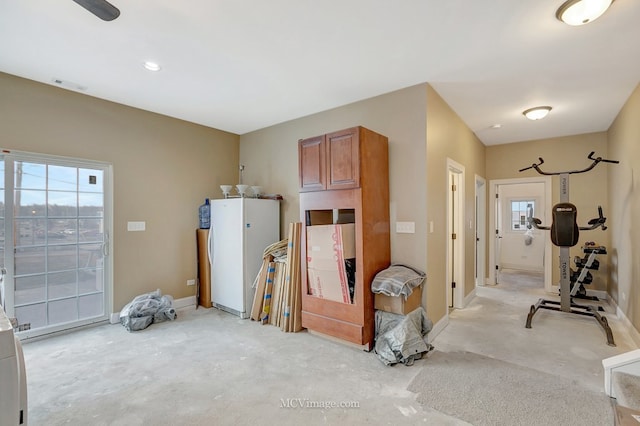 interior space featuring visible vents, concrete floors, and baseboards