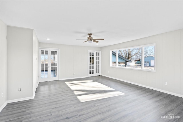 unfurnished room with french doors, ceiling fan, and dark hardwood / wood-style floors