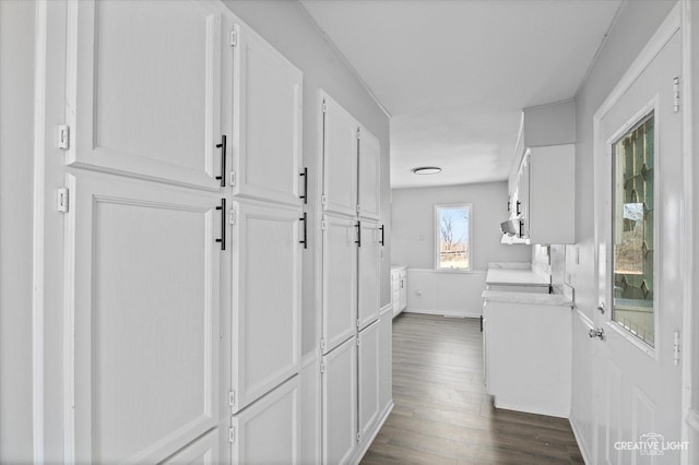 corridor with dark hardwood / wood-style flooring