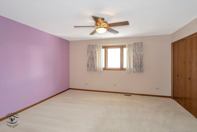 unfurnished bedroom featuring a closet, light colored carpet, visible vents, and baseboards