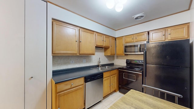 8640 Waukegan Rd Unit 227, Morton Grove, IL 60053 - kitchen featuring black appliances, a sink, light tile patterned floors, decorative backsplash, and dark countertops