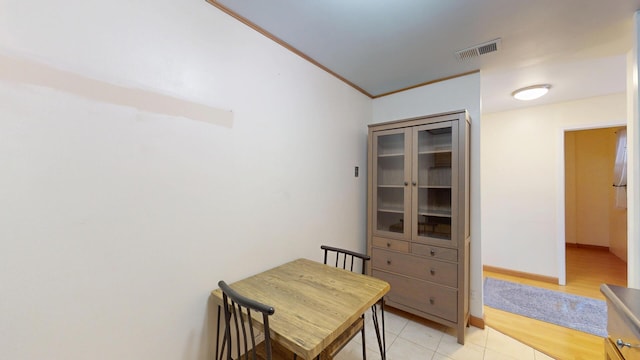 8640 Waukegan Rd Unit 227, Morton Grove, IL 60053 - dining area featuring light tile patterned floors, ornamental molding, and baseboards