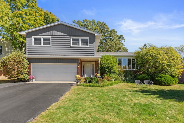 view of front facade featuring brick siding, driveway, a front yard, and a garage