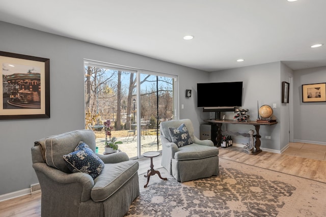 living room with recessed lighting, baseboards, and wood finished floors