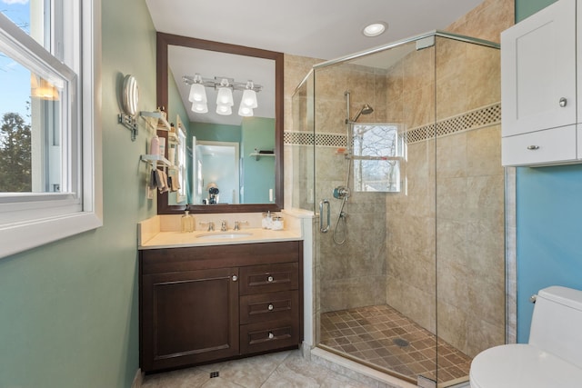 full bath with toilet, a stall shower, and vanity