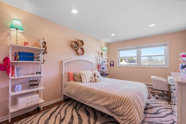 bedroom with recessed lighting, a baseboard radiator, baseboards, and wood finished floors