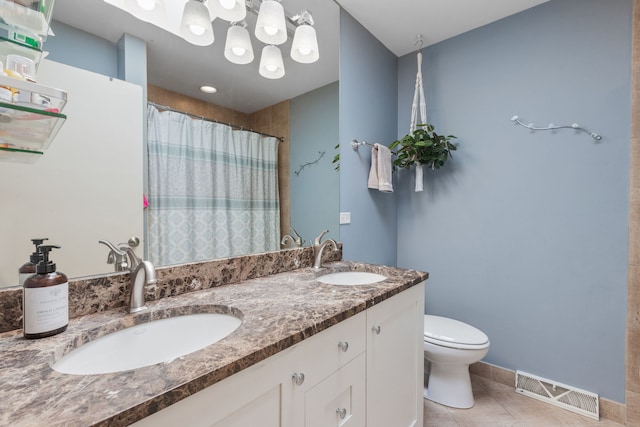 bathroom featuring tile patterned flooring, toilet, visible vents, and a sink