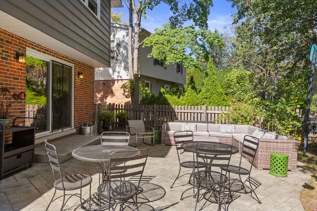 view of patio / terrace featuring outdoor lounge area and fence