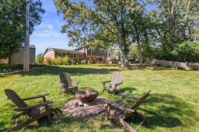 view of yard featuring a fire pit and fence