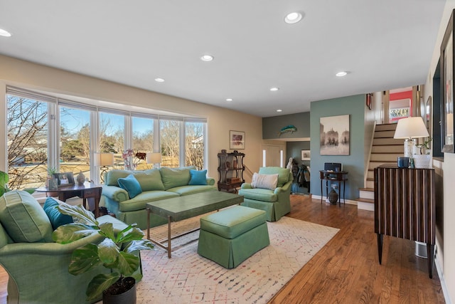 living room featuring stairs, recessed lighting, wood finished floors, and baseboards