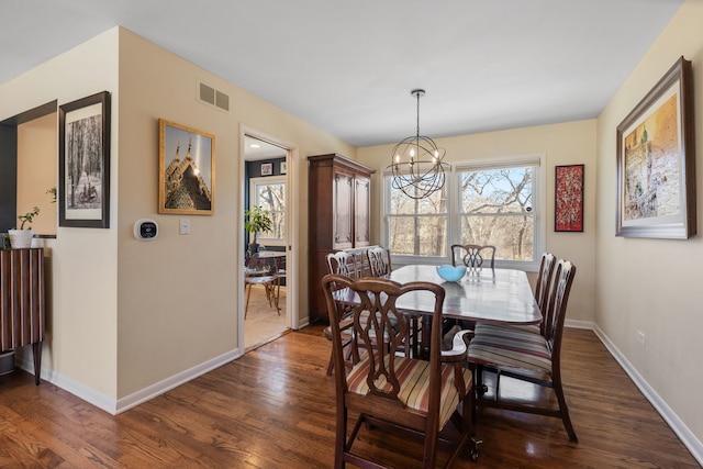 dining space with visible vents, baseboards, an inviting chandelier, and dark wood-style flooring