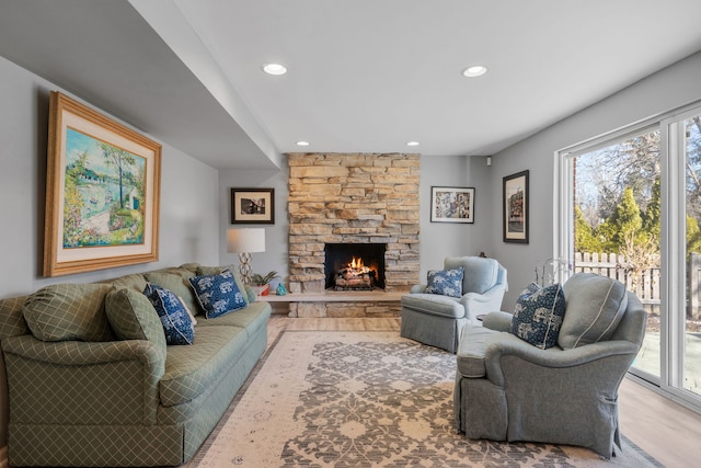 living area featuring recessed lighting, a healthy amount of sunlight, and a fireplace