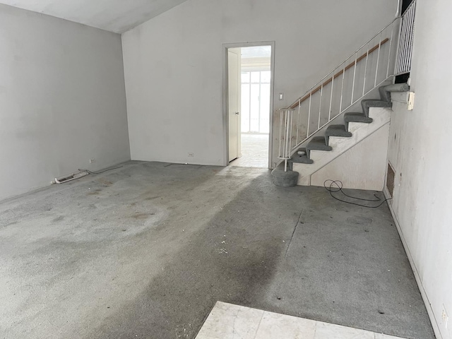 unfurnished living room with vaulted ceiling