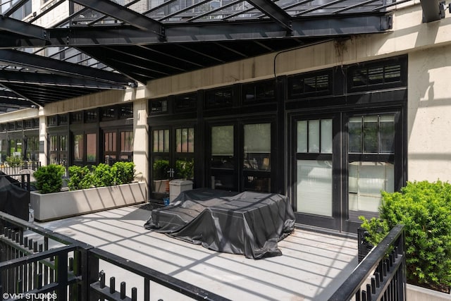 wooden terrace featuring grilling area and french doors