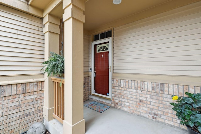 doorway to property featuring brick siding