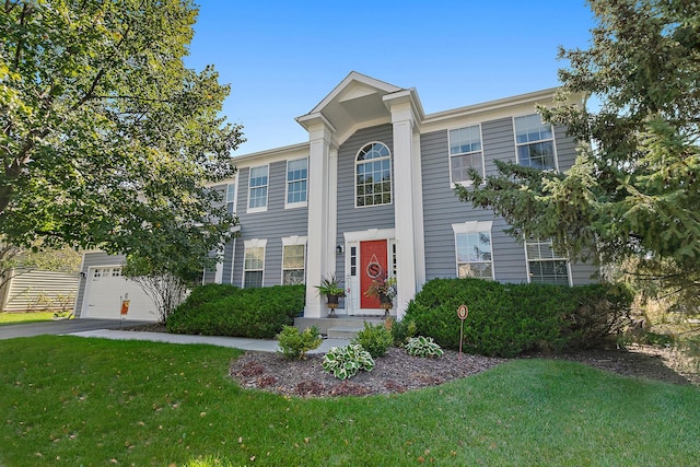 view of front facade with a front yard and a garage