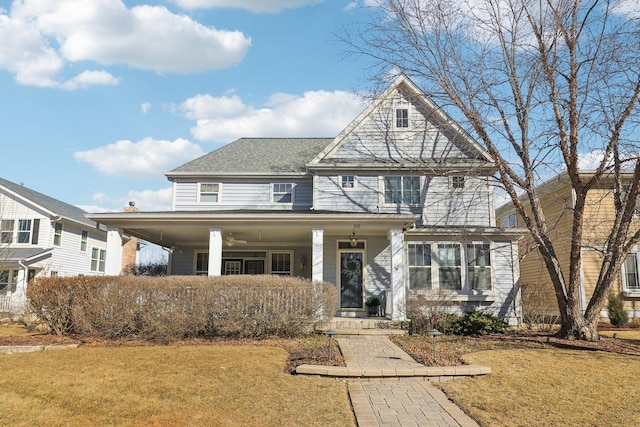 view of front of home featuring covered porch and a front lawn