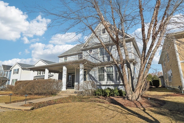 view of front of property featuring covered porch and a front lawn